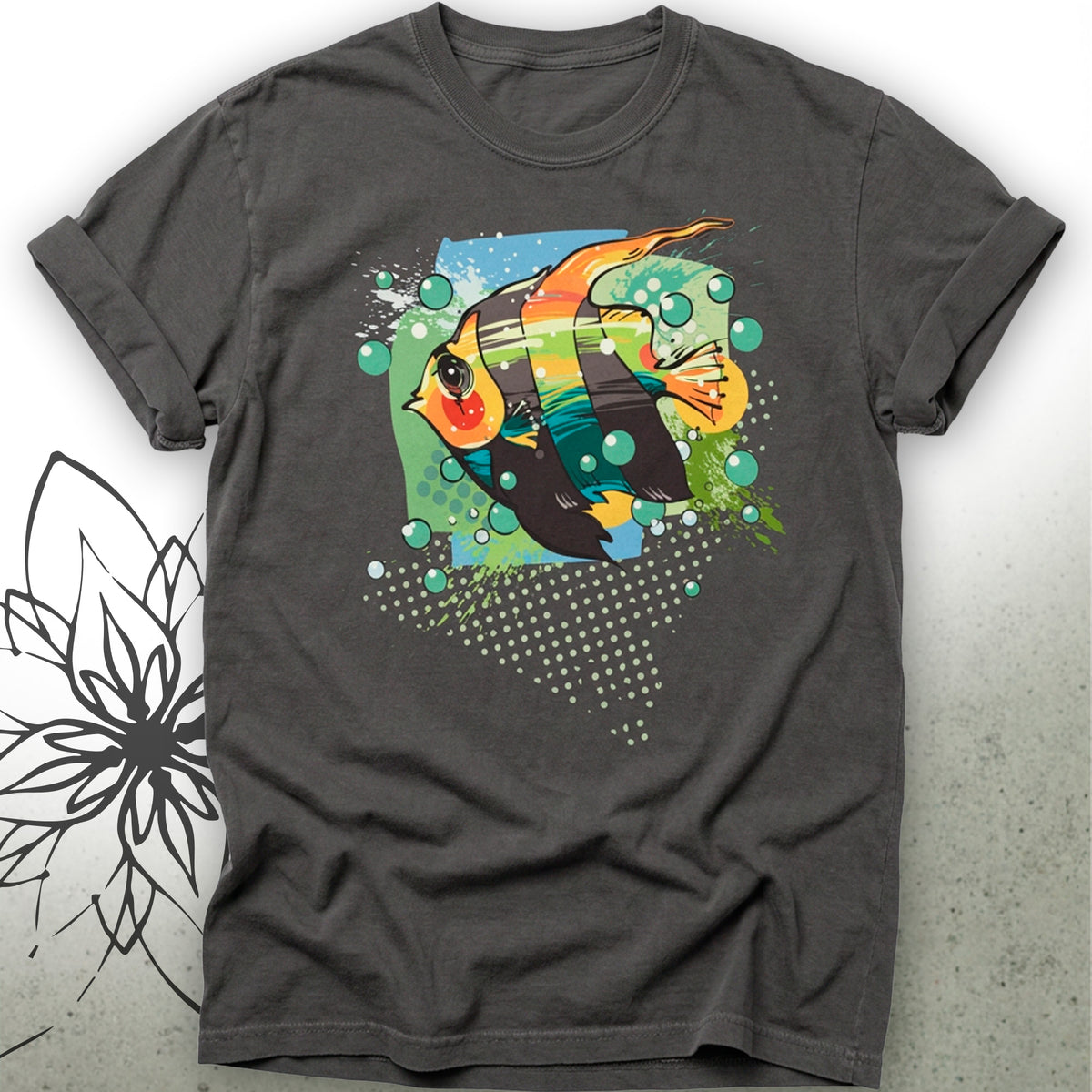 A dark gray crewneck t-shirt featuring a colorful graphic print of a tropical fish with green bubbles and a halftone dot pattern, displayed against a light gray textured background.