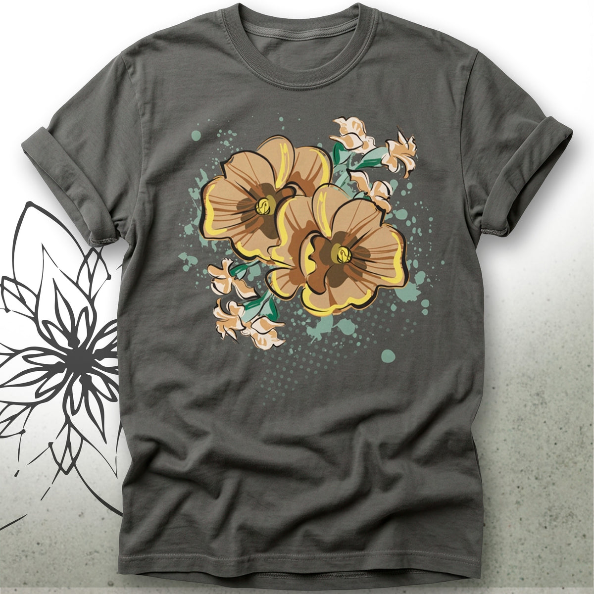 A dark gray crewneck t-shirt featuring a graphic print of three yellow and brown pansies with green leaves and teal paint splatters on the front, displayed against a light gray background with a black floral line art illustration on the left.