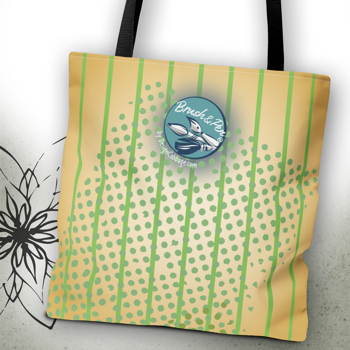 A canvas tote bag with black handles, featuring a light yellow and green pattern of vertical stripes and dots. A circular blue and white 'Brush&Pen'.