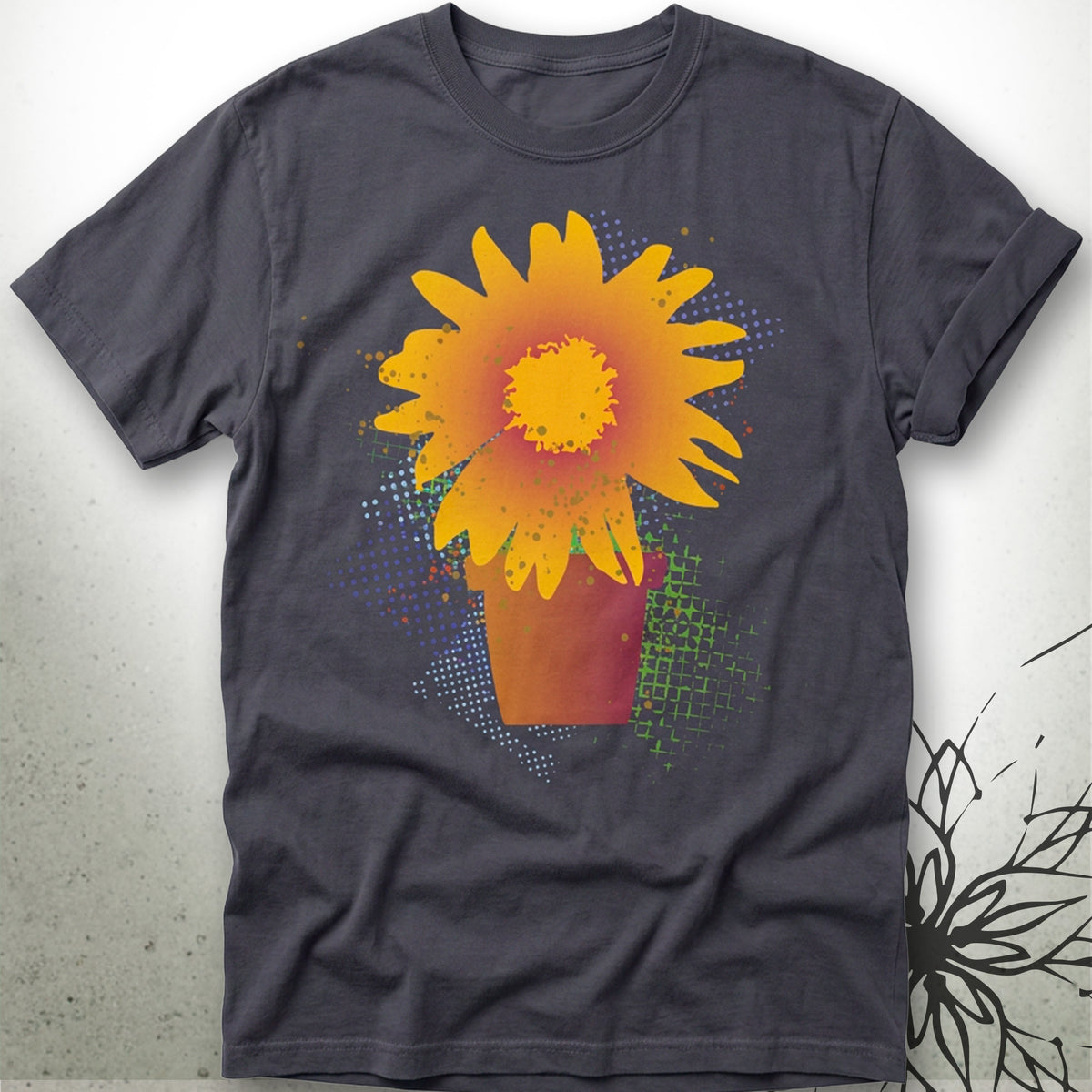 A dark gray crewneck t-shirt featuring a vibrant graphic print of a yellow and orange sunflower in a pot, displayed against a light gray textured background.
