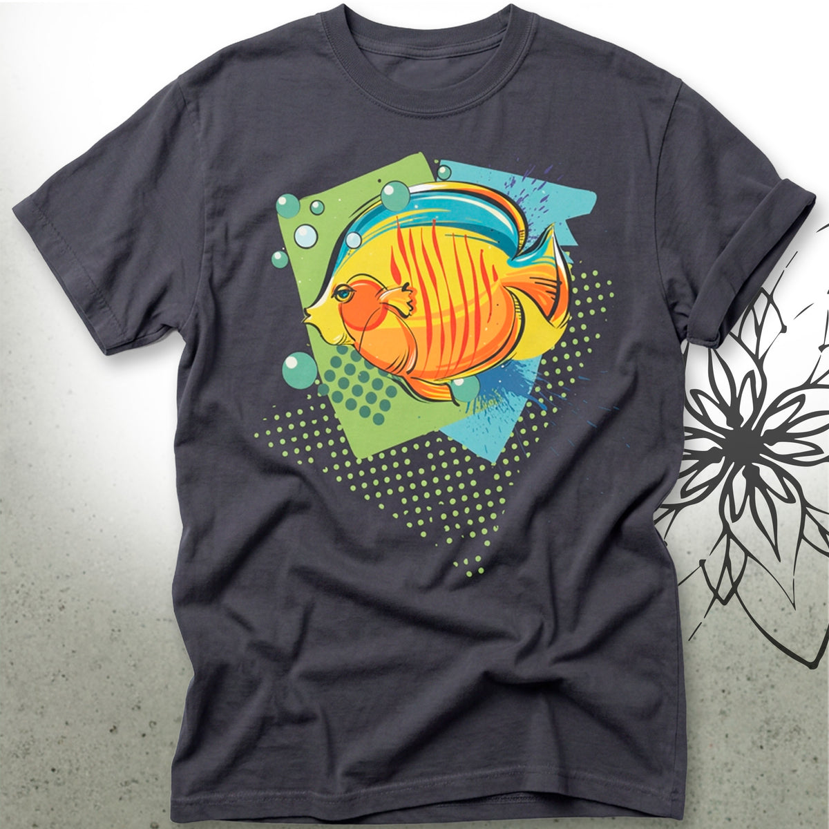 A dark charcoal gray t-shirt featuring a colorful graphic print of a striped orange and yellow fish swimming over a green and blue geometric background with bubbles.