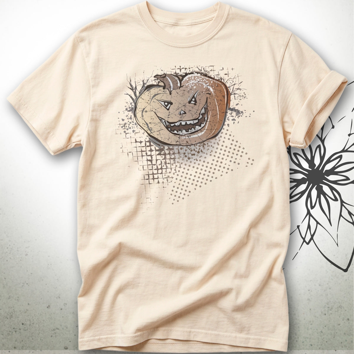 A light beige crewneck t-shirt featuring a graphic print of a smiling jack-o'-lantern pumpkin with a distressed, grunge-style design on the front.